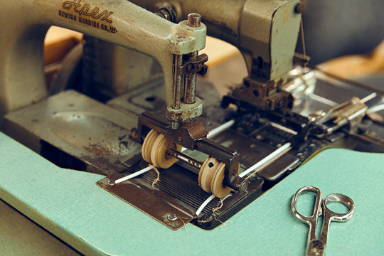 Photo of a person sanding a chair frame.